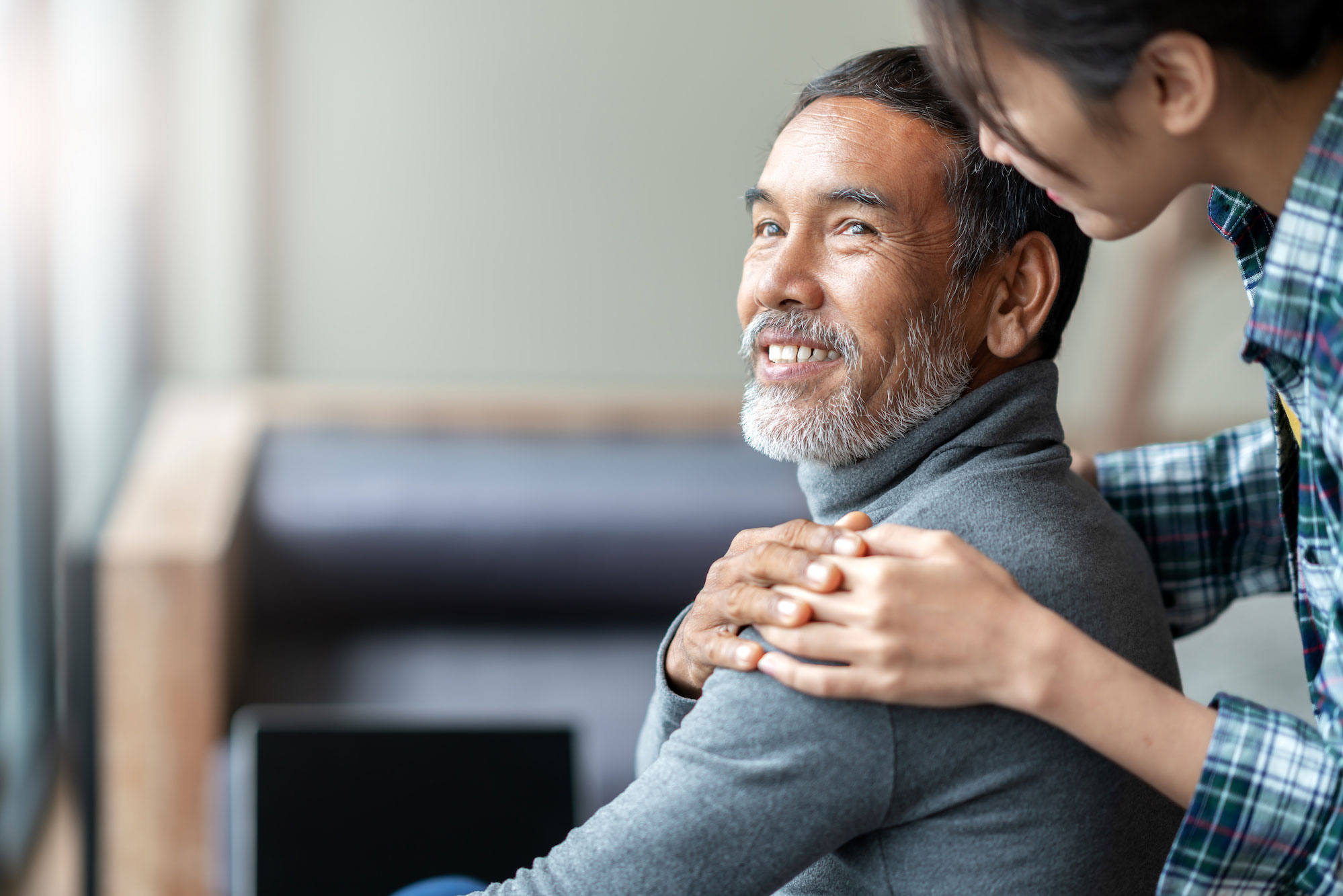 A young woman hugging her father.